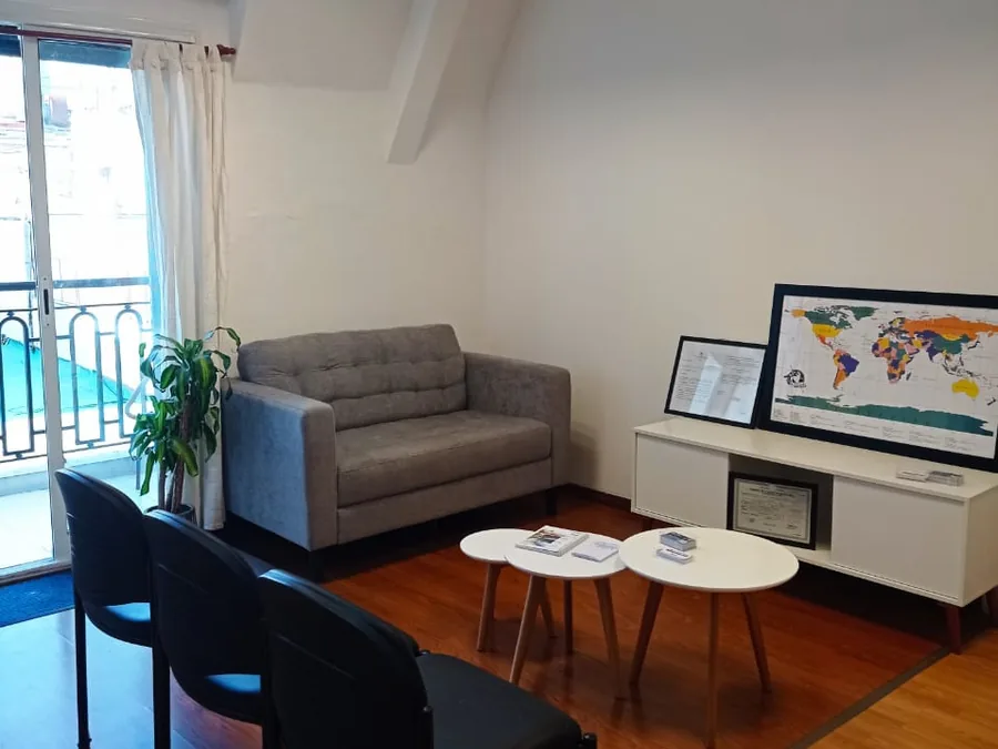 The waiting room at our Buenos Aires office, with the framed certificates and the balcony onto San Martín Street