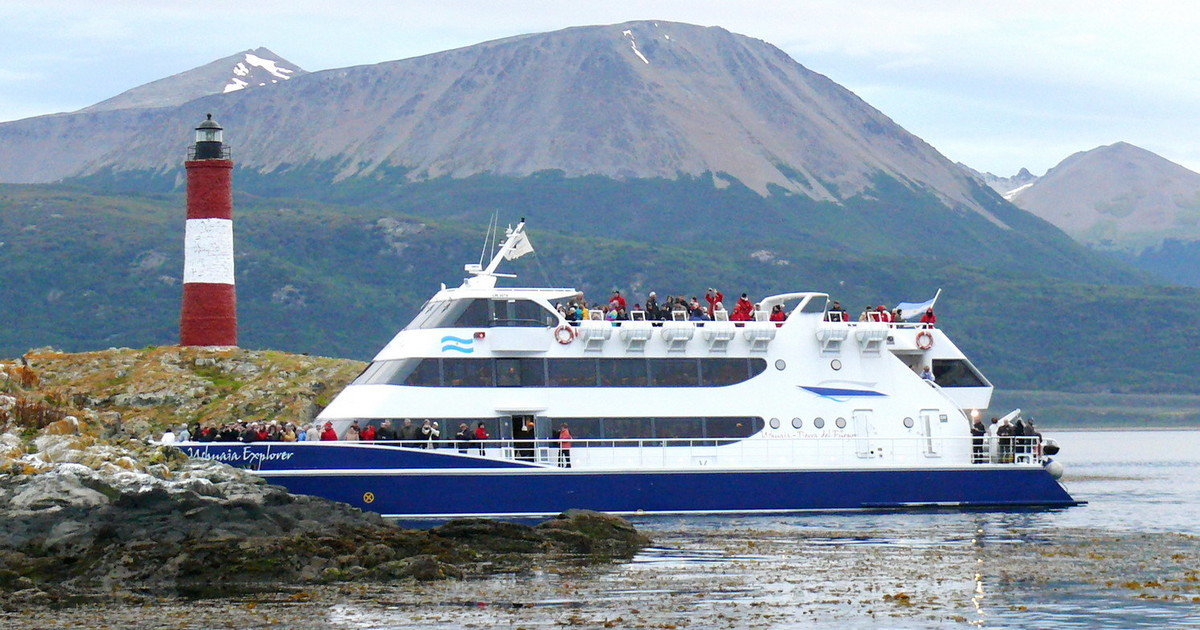 Catamaran sailing past the Les Eclaireurs lighthouse in the Beagle Channel, Ushuaia