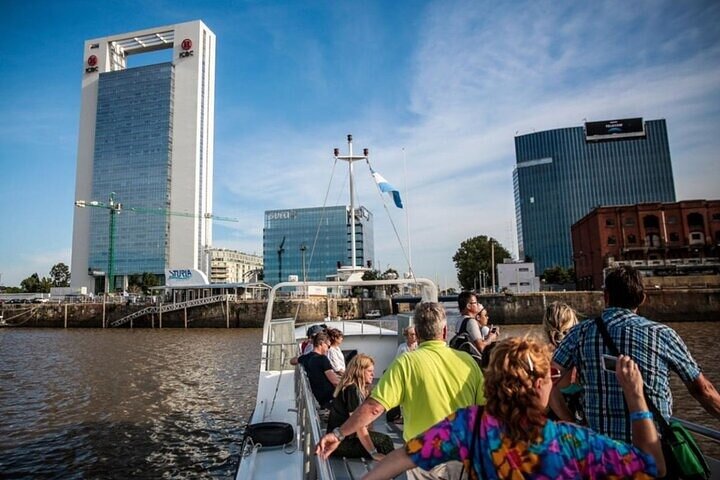 Passengers on deck leaving Puerto Madero with the Buenos Aires skyline behind