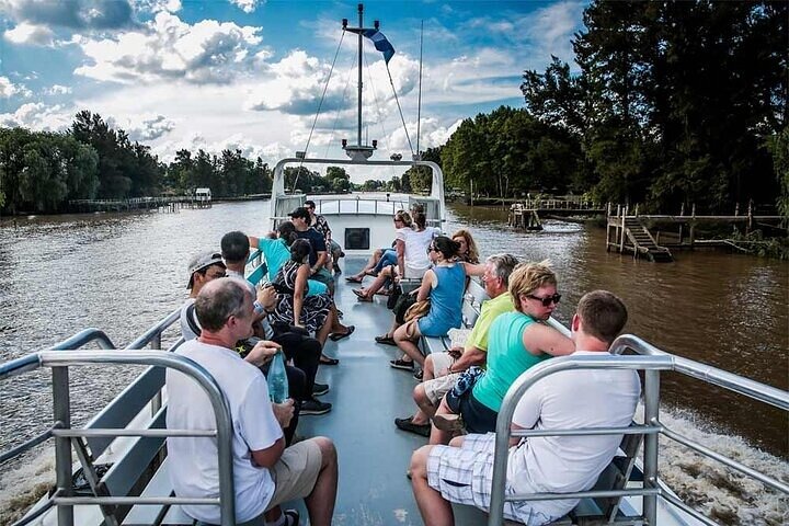 Passengers on deck cruising the channels of the Paraná Delta