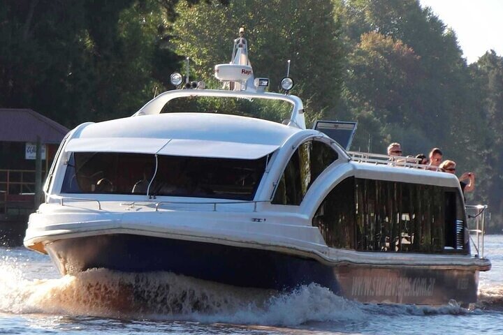 The boat cruising the channels of the Paran&aacute; Delta with passengers on deck