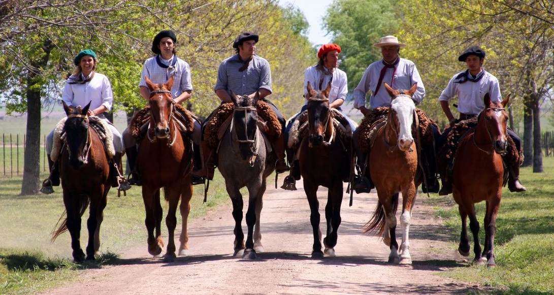 Gauchos on horseback at an estancia in the Buenos Aires pampas