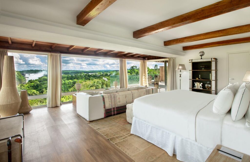 A room at the Melia Iguazu with floor-to-ceiling windows over the rainforest and the mist of the falls