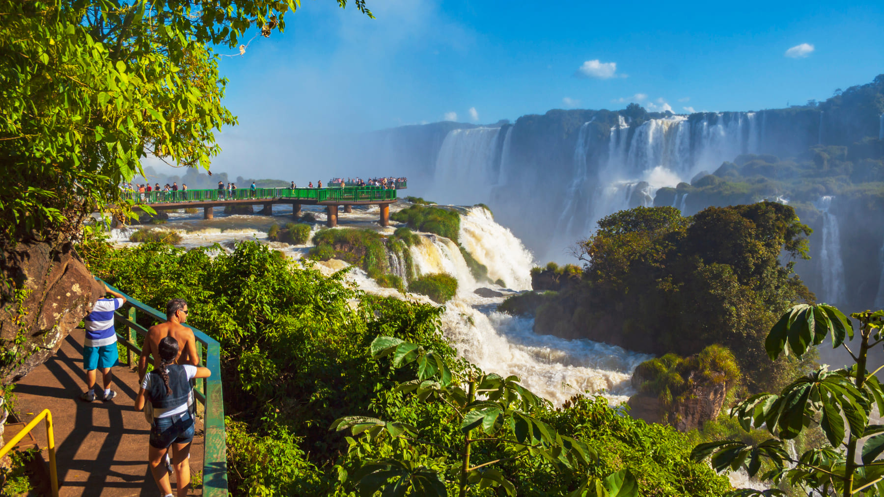 Visitors on the walkway facing the Iguazu Falls on the Argentine side