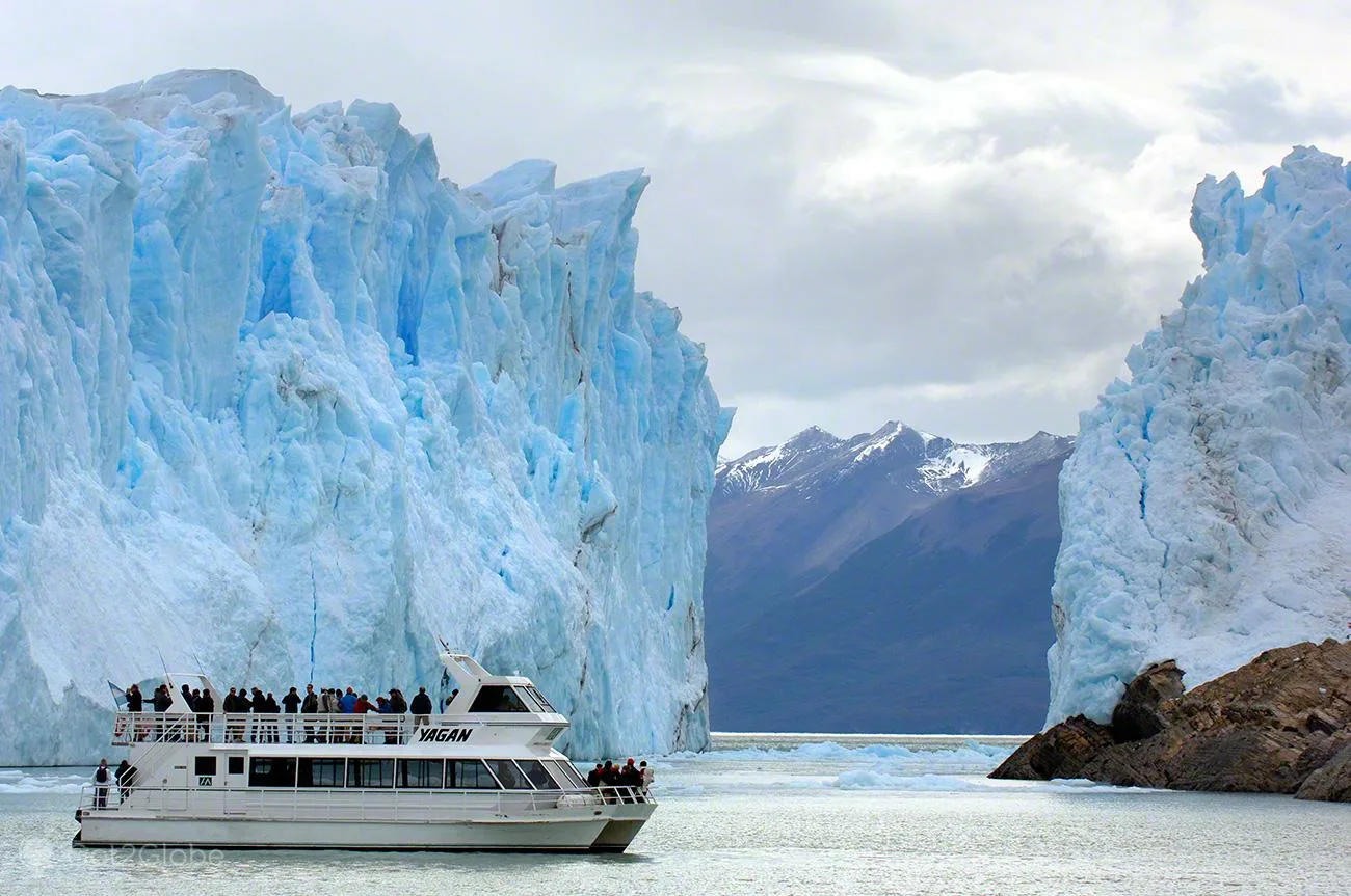 A catamaran sailing between the ice walls at the front of the Perito Moreno Glacier