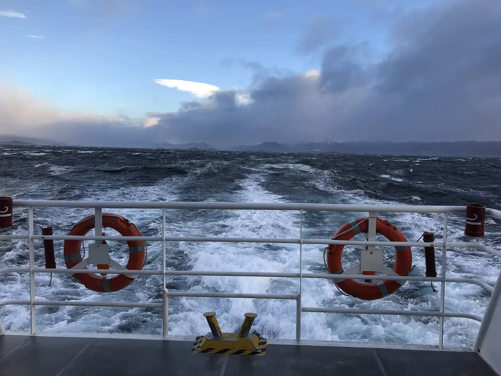 The stern of the catamaran and its wake across the Beagle Channel